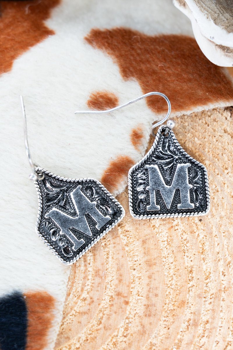 TIPI Cattle Tag 'M' Silvertone Earrings - Wholesale Accessory Market
