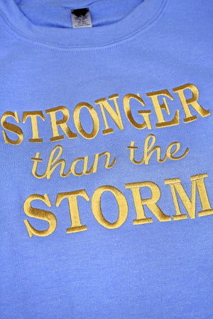 Embroidered Stronger Than The Storm Unisex NuBlend Crew Sweatshirt - Wholesale Accessory Market